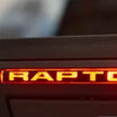 Close-up of a 'Raptor' logo on a dark background