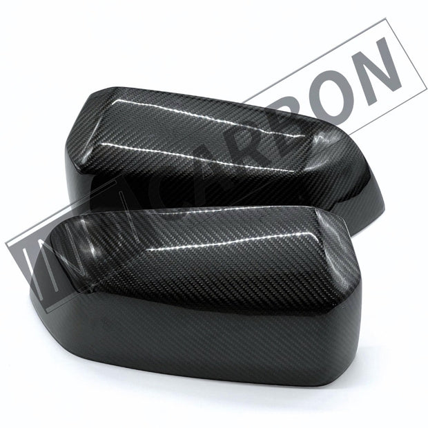 Two carbon fiber mirror covers on a white background with 'Carbon' branding.